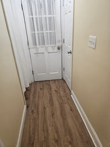 a view of room with wooden floor