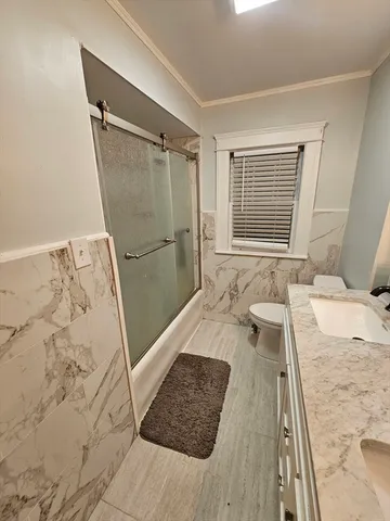 a bathroom with a tub shower and sink
