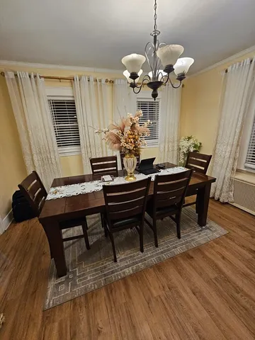 a view of a dining room with furniture and wooden floor