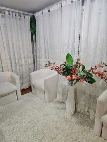 a white bath tub sitting next to a white curtain