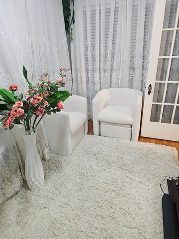 a living room with furniture and flowers