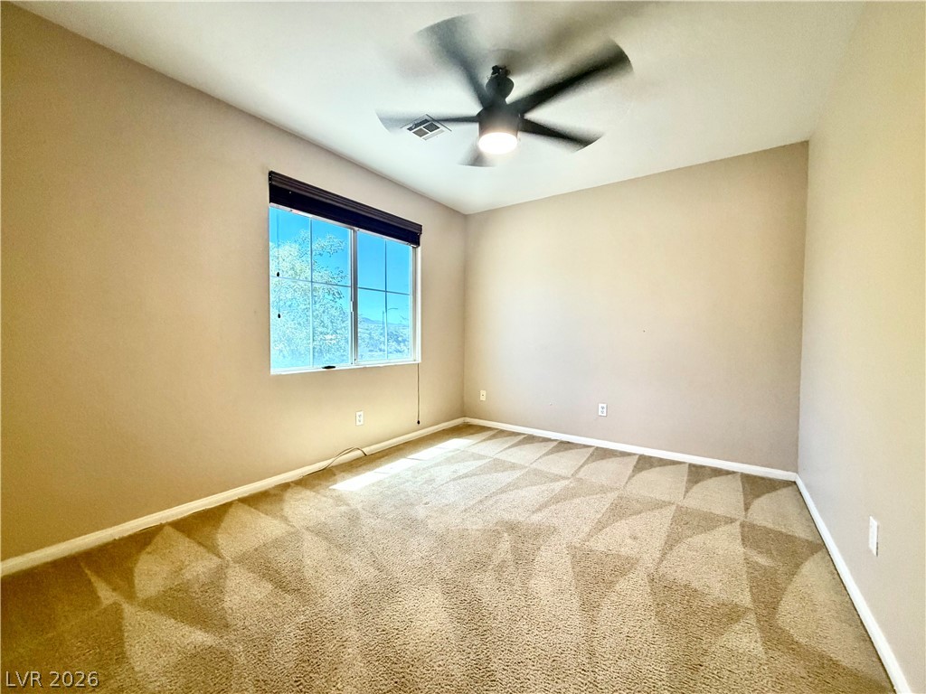 3936 Gold Point Street Las Vegas, NV 89129 - Photo 8 of 23 A window-filled bedroom with soft carpet provides a peaceful retreat.