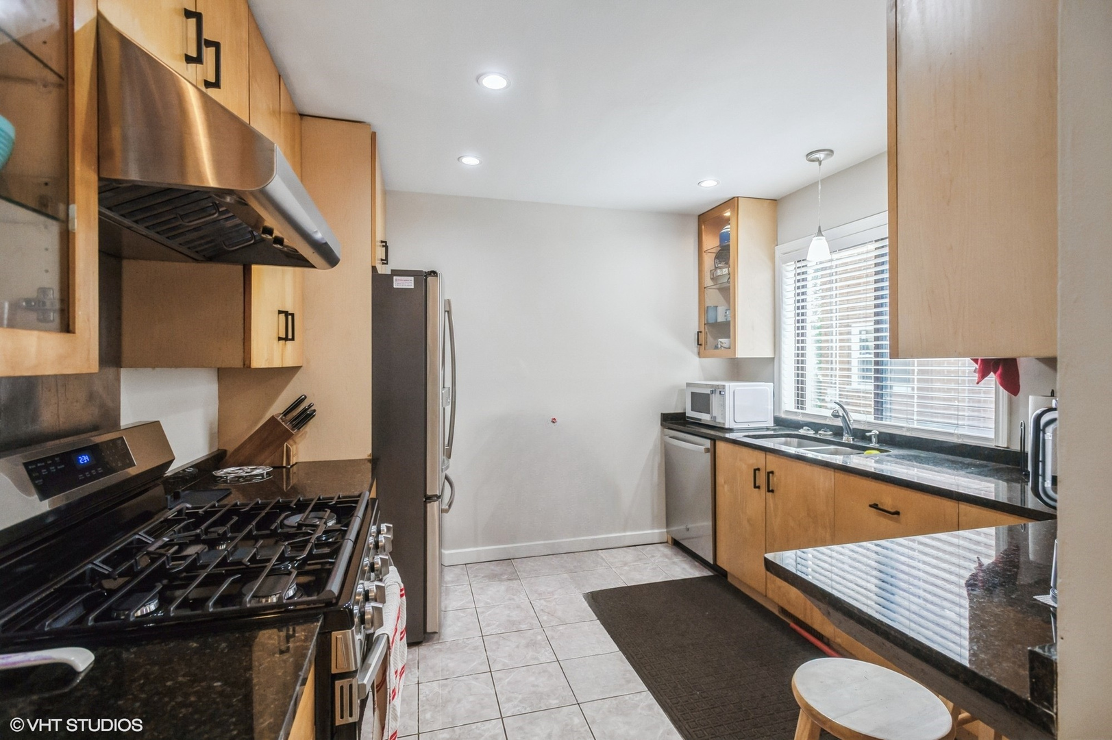 10021 Frontage Road, Unit F Skokie, IL 60077 - Photo 11 of 25 a kitchen with stainless steel appliances granite countertop a sink stove and refrigerator