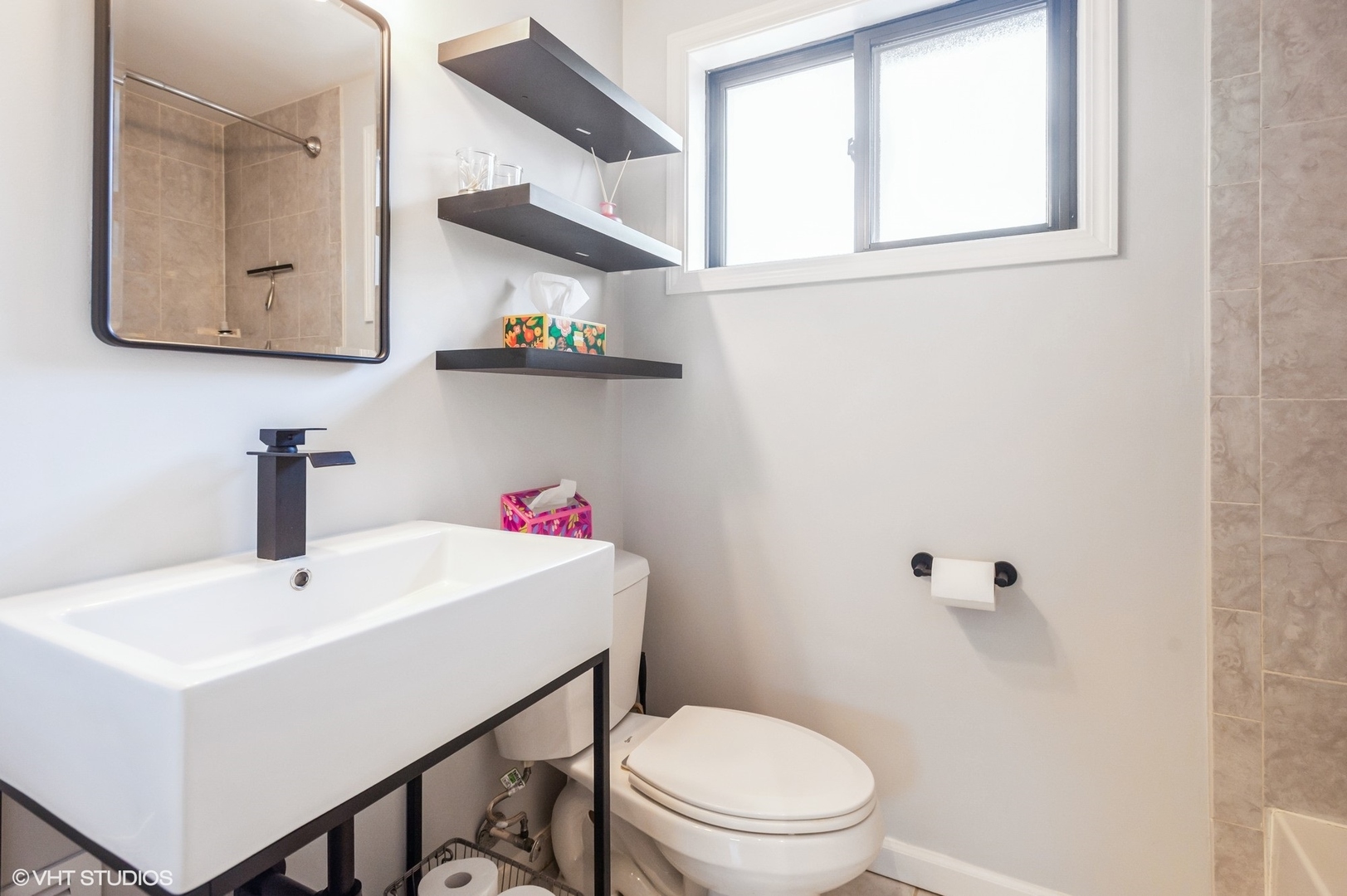10021 Frontage Road, Unit F Skokie, IL 60077 - Photo 17 of 25 a bathroom with a sink mirror and toilet