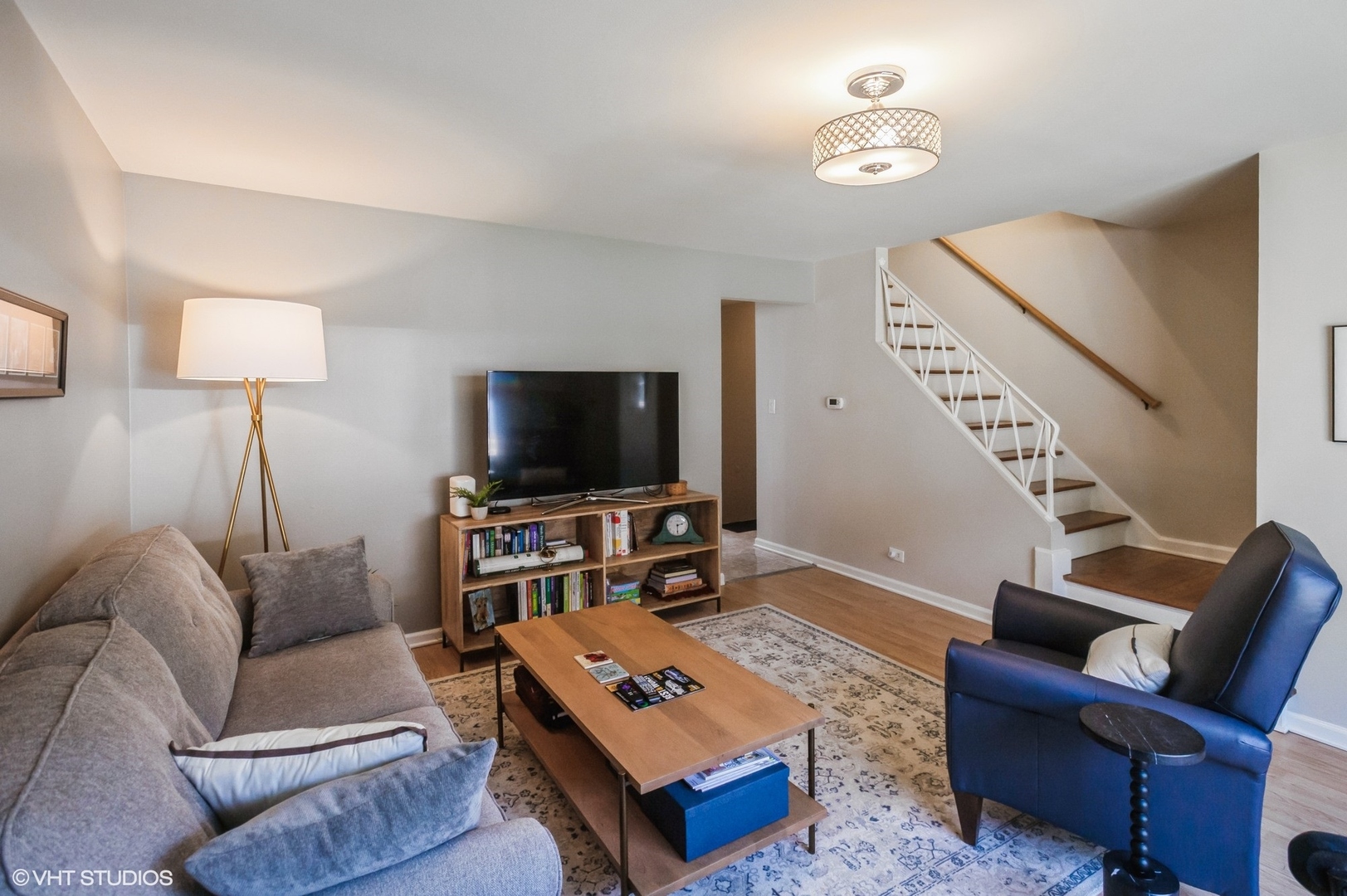 10021 Frontage Road, Unit F Skokie, IL 60077 - Photo 7 of 25 a living room with furniture and a flat screen tv