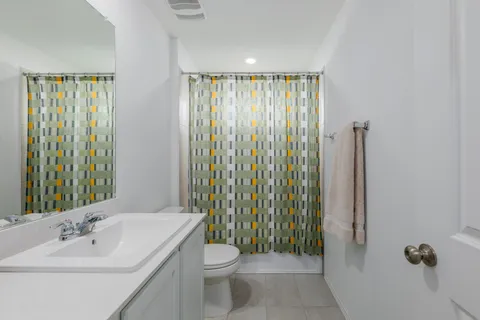a bathroom with a toilet a sink and a mirror