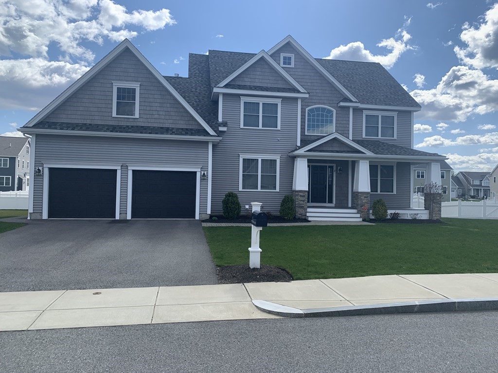 8 Watson Lane Woburn, MA 01801 - Photo 1 of 1 a front view of a house with a yard and garage