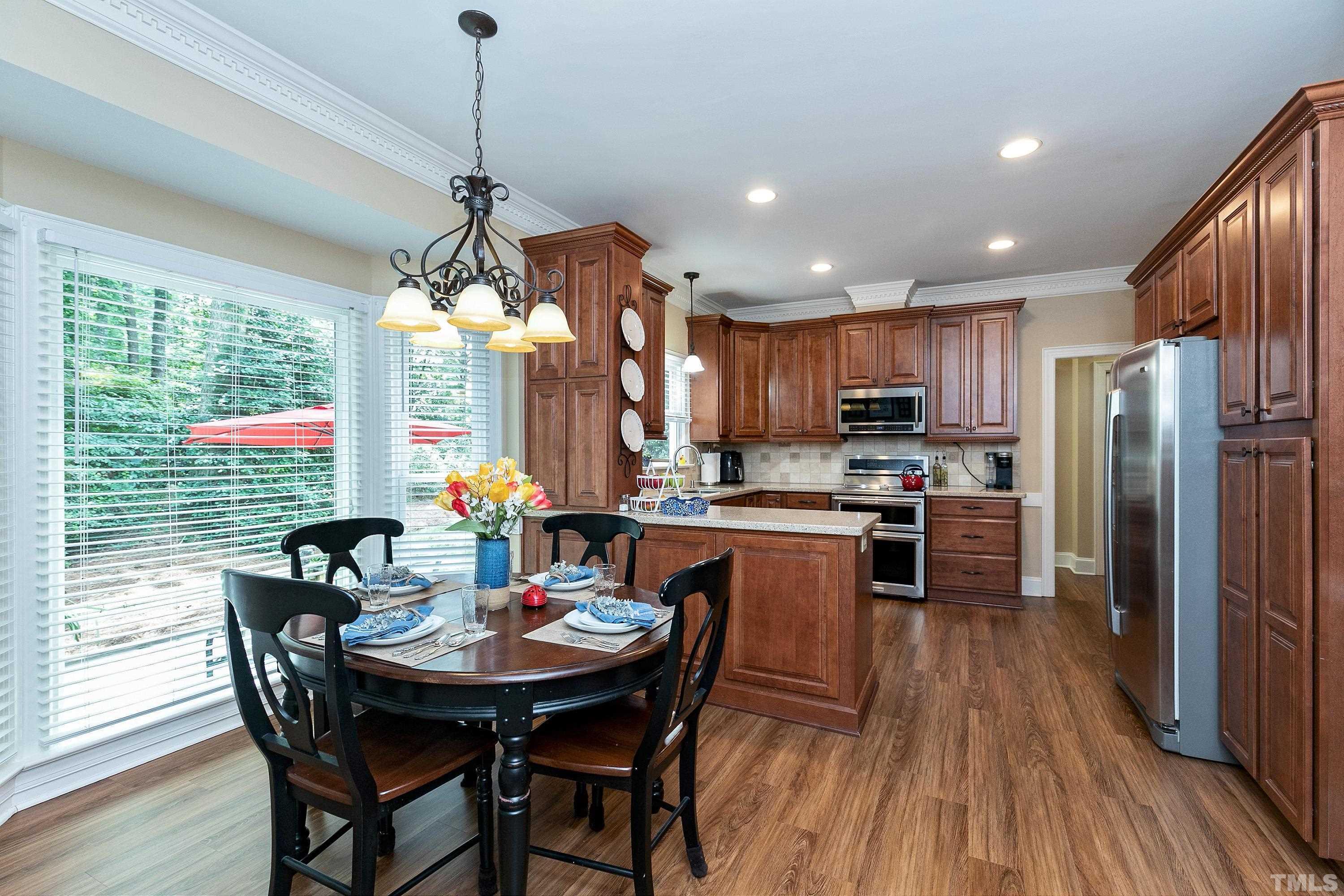 2905 Kenwick Court Raleigh, NC 27613 - Photo 12 of 45 a view of a dining room with furniture window and wooden floor
