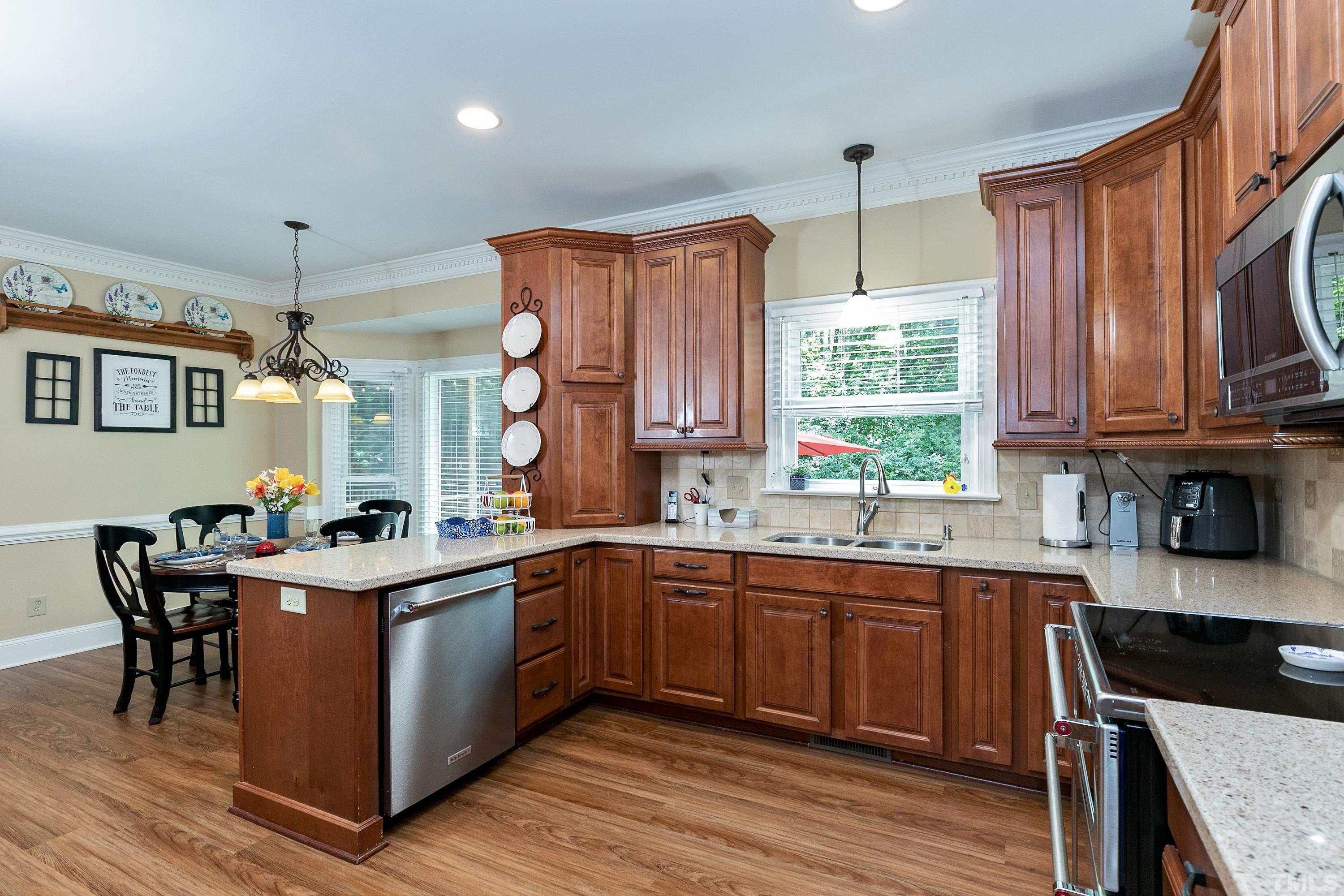 2905 Kenwick Court Raleigh, NC 27613 - Photo 14 of 45 a kitchen with a sink stove and cabinets