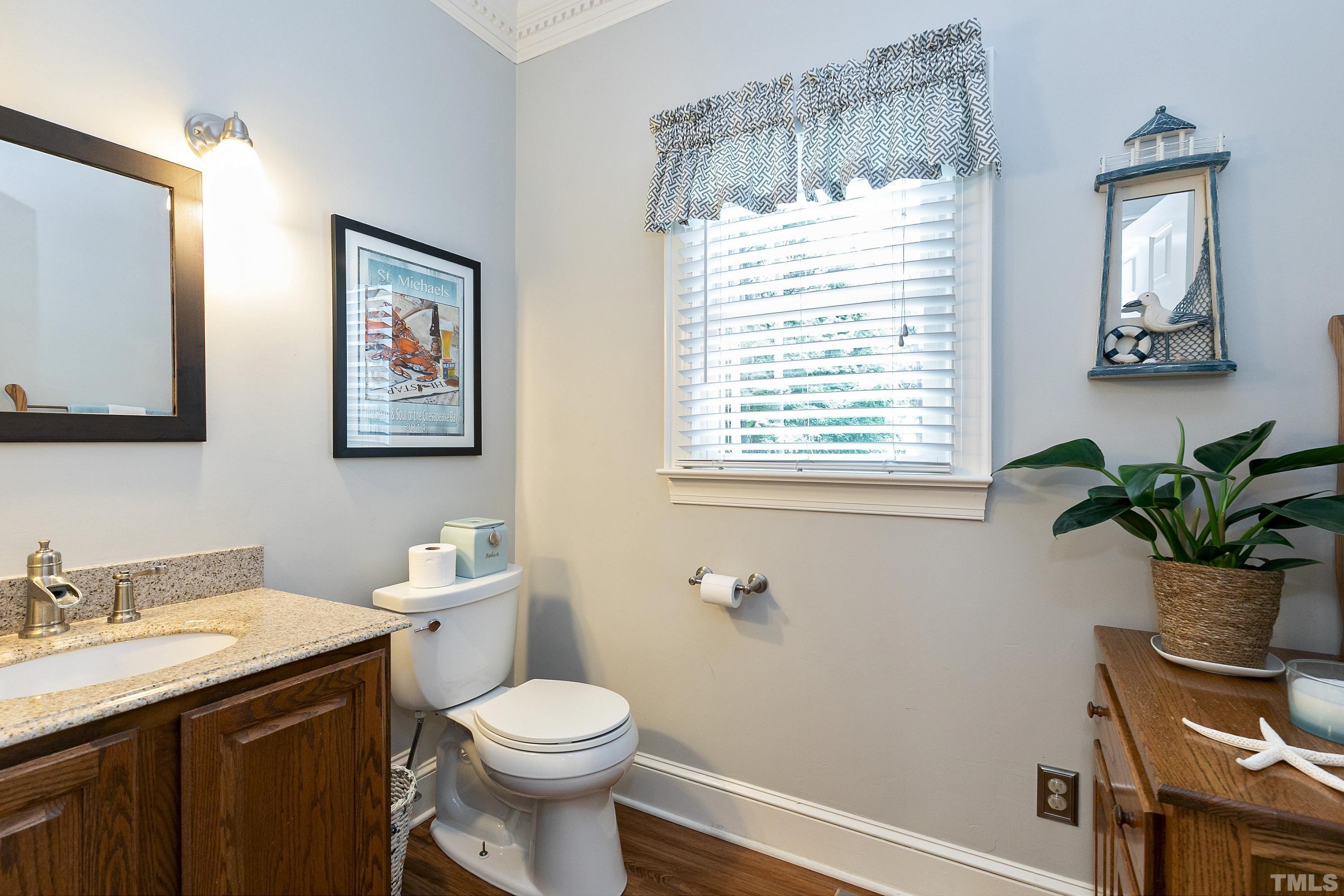 2905 Kenwick Court Raleigh, NC 27613 - Photo 18 of 45 a bathroom with a toilet sink and mirror