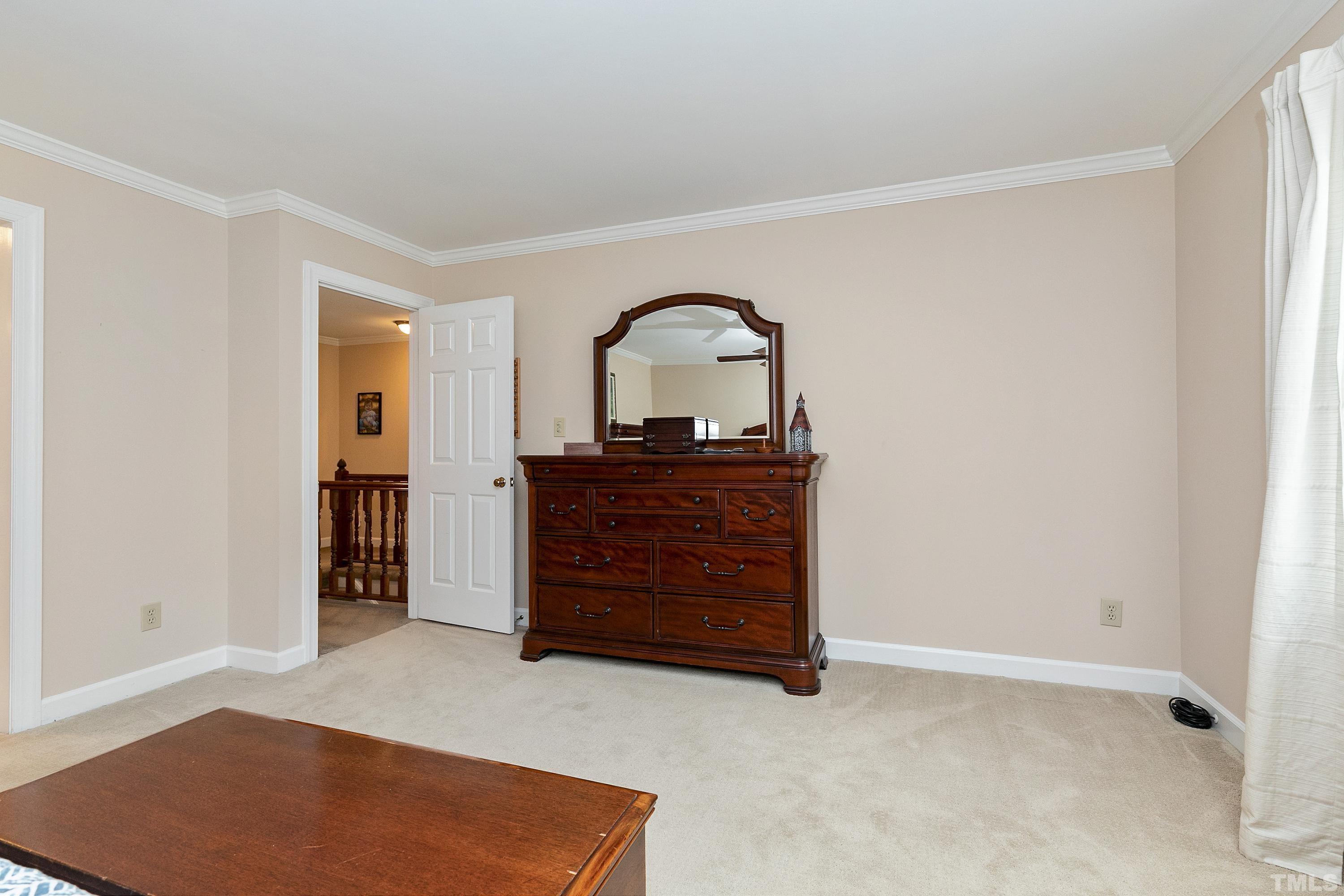 2905 Kenwick Court Raleigh, NC 27613 - Photo 23 of 45 an empty room with a dresser and a mirror