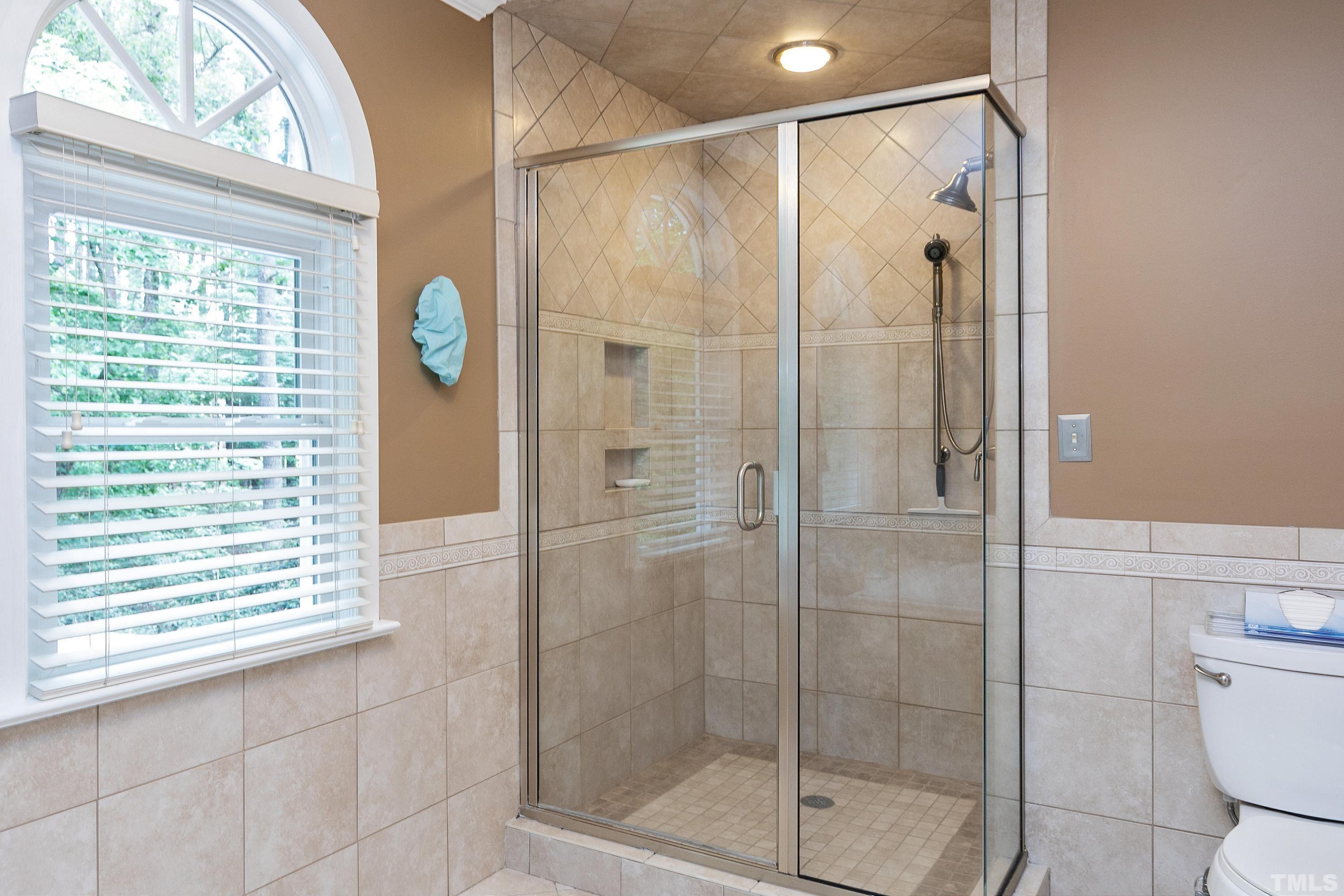 2905 Kenwick Court Raleigh, NC 27613 - Photo 27 of 45 a bathroom with a shower and a window