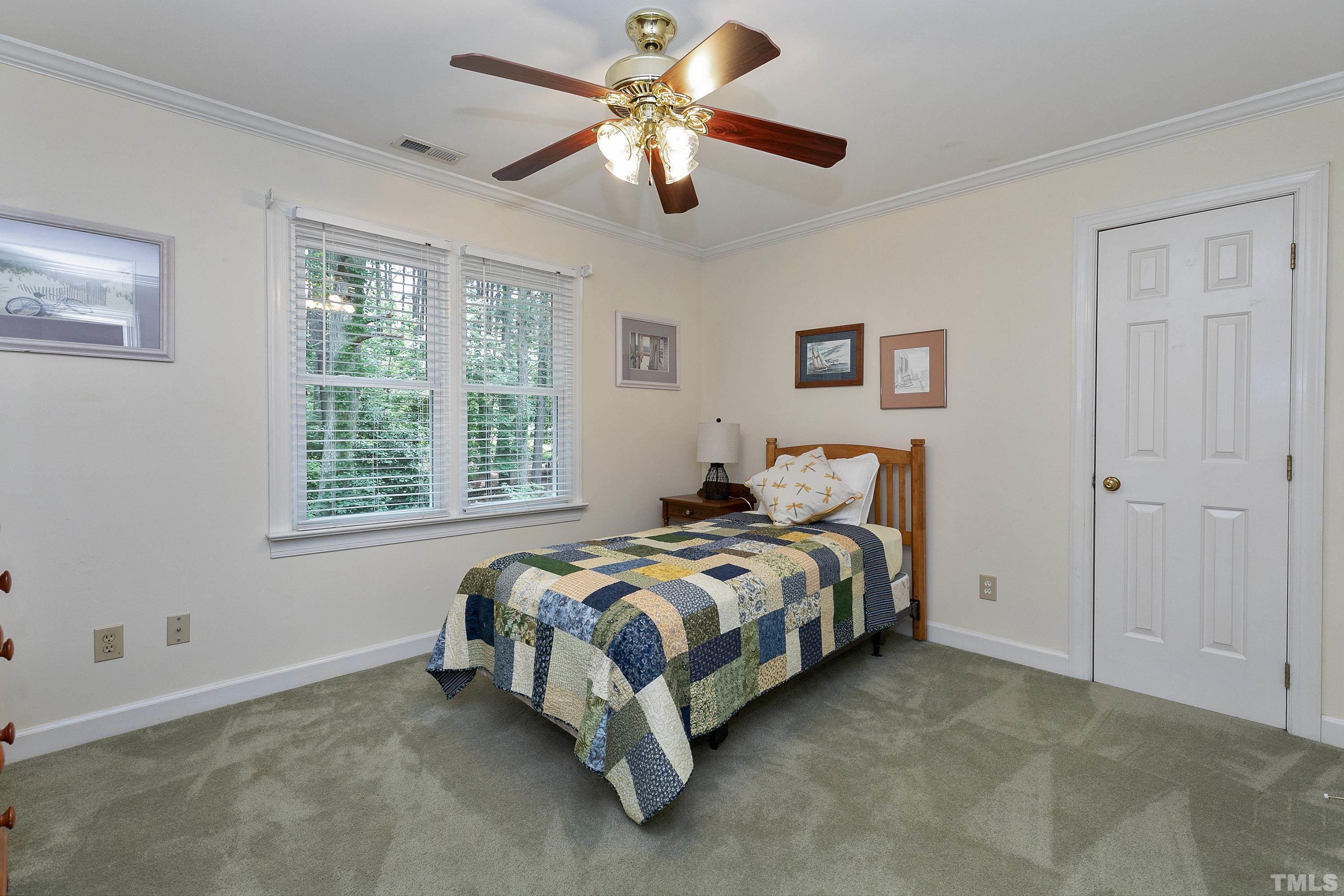 2905 Kenwick Court Raleigh, NC 27613 - Photo 29 of 45 a bed room with bed and a ceiling fan