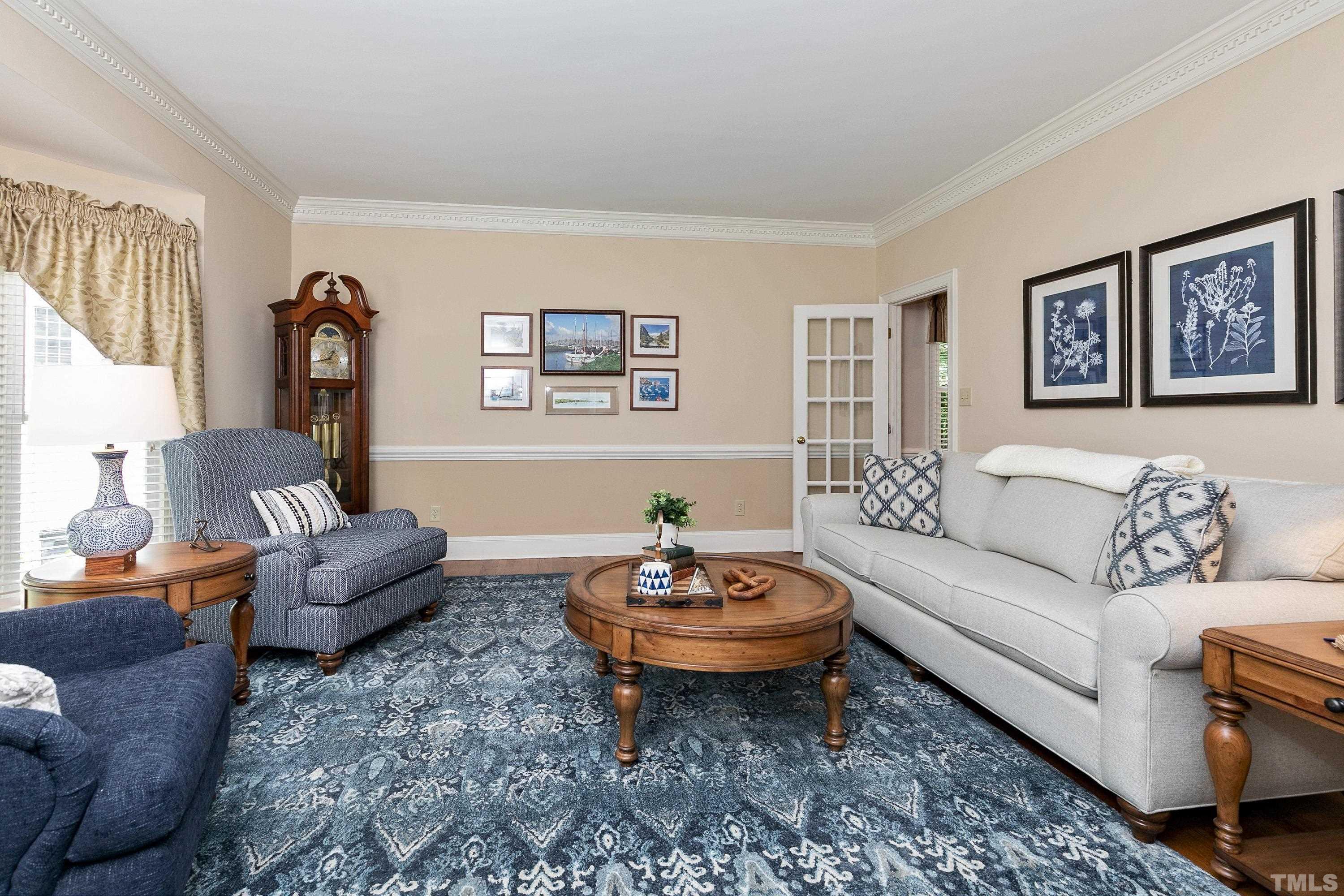 2905 Kenwick Court Raleigh, NC 27613 - Photo 5 of 45 a living room with furniture a rug and wall paintings