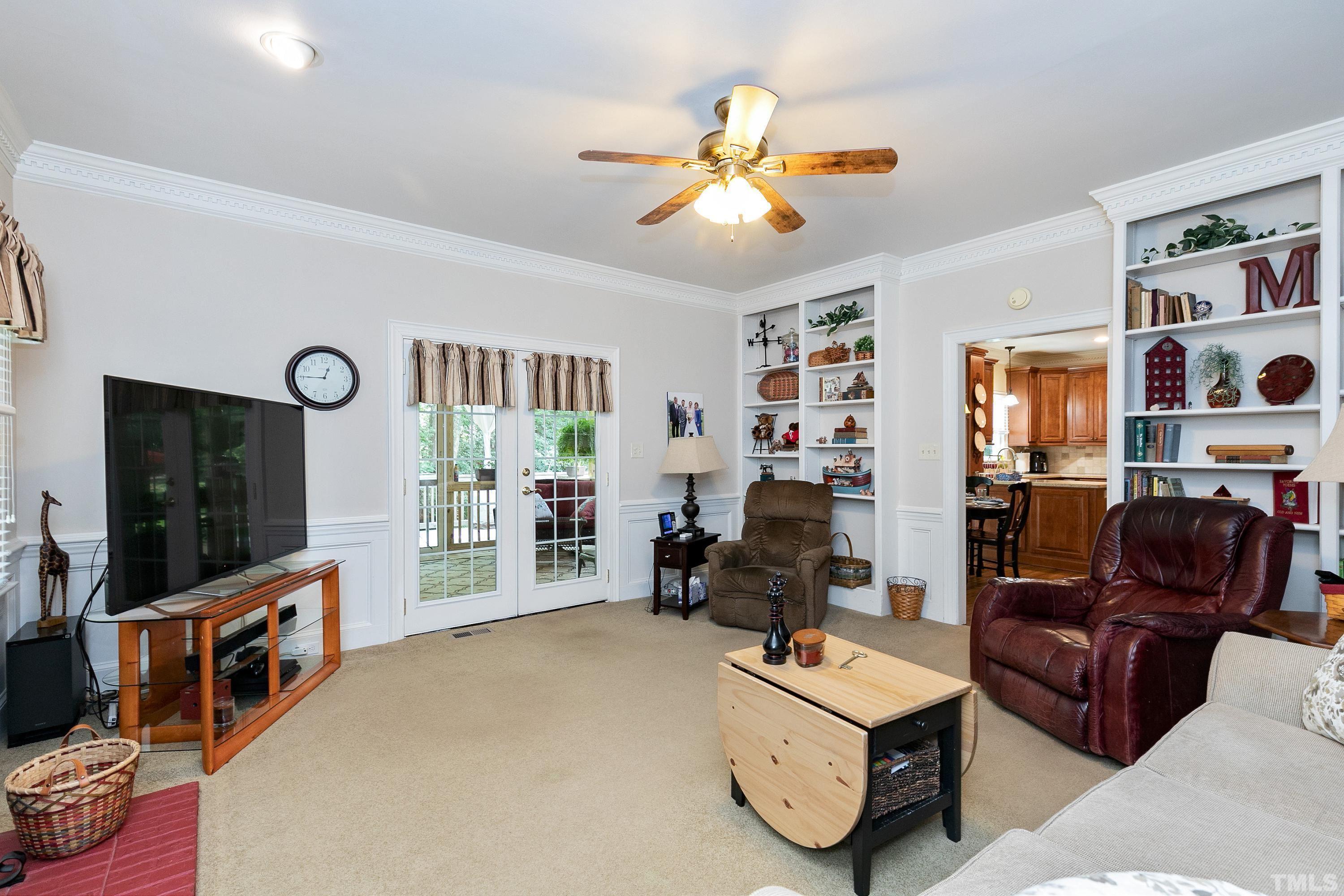 2905 Kenwick Court Raleigh, NC 27613 - Photo 7 of 45 a living room with furniture and a flat screen tv