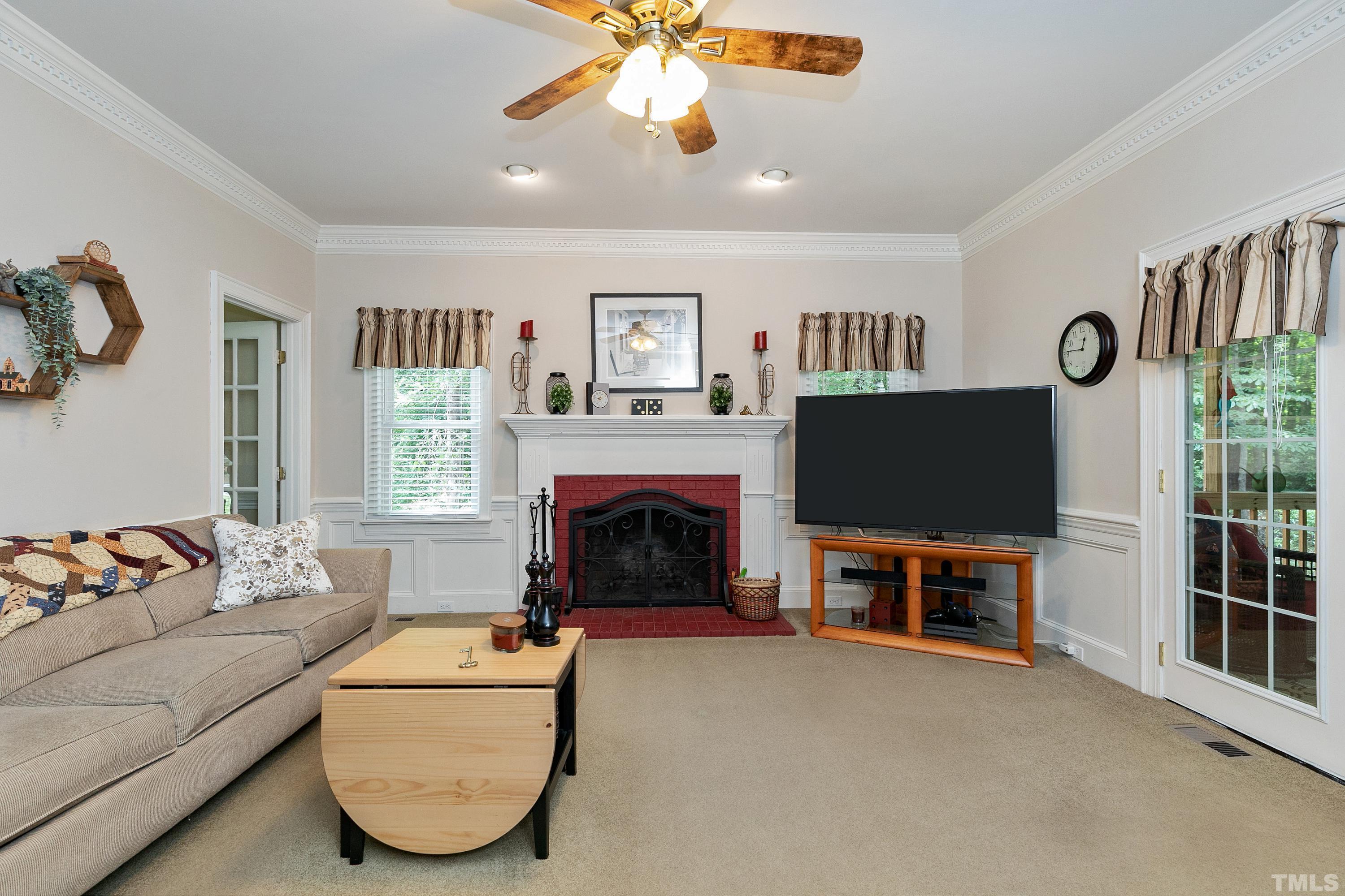 2905 Kenwick Court Raleigh, NC 27613 - Photo 9 of 45 a living room with furniture a flat screen tv and a fireplace