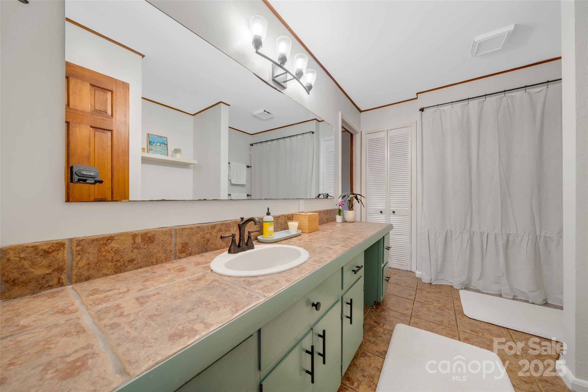 3124 Clark Loop Morganton, NC 28655 - Photo 16 of 48 a bathroom with a granite countertop sink and a mirror