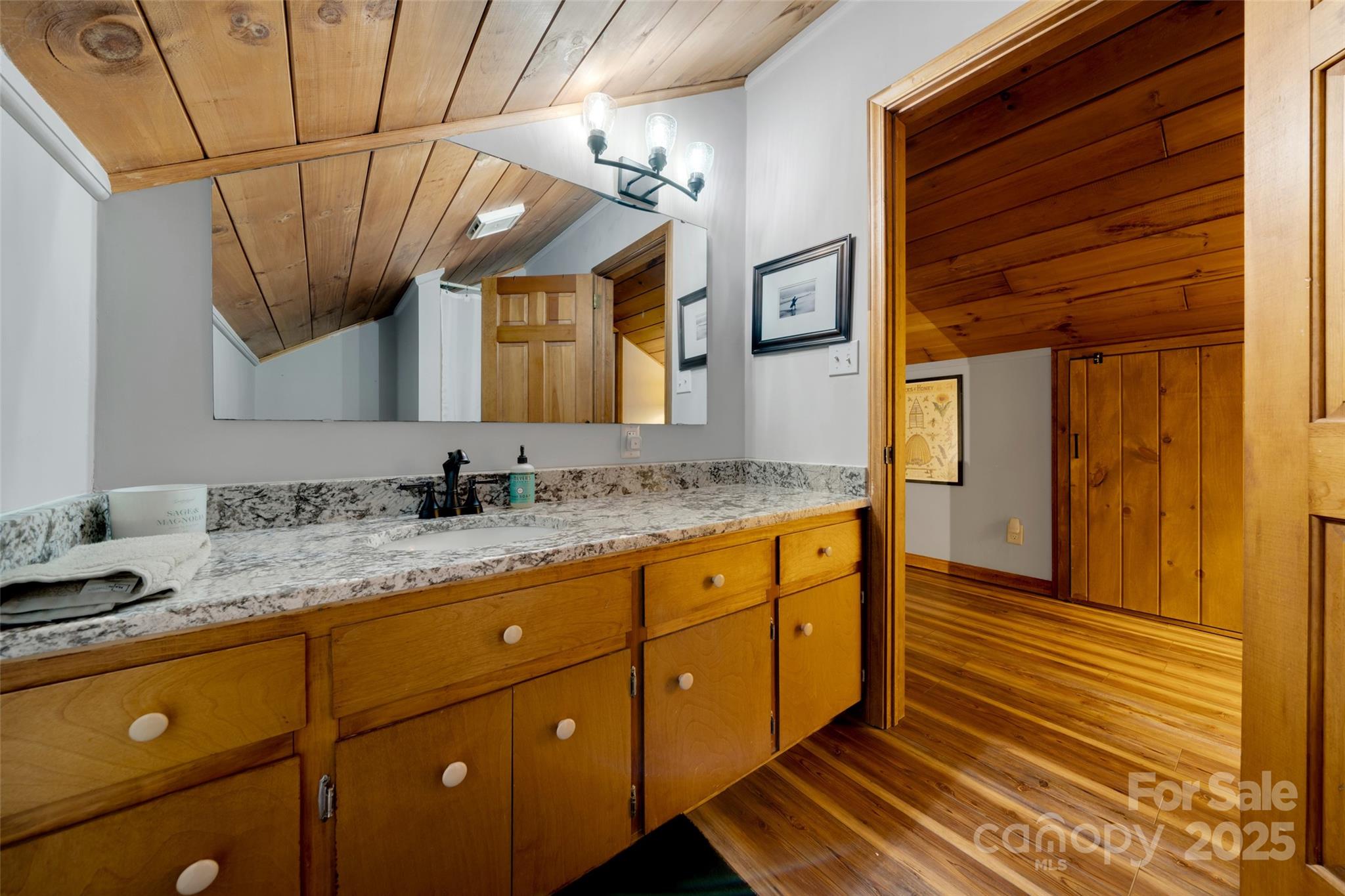 3124 Clark Loop Morganton, NC 28655 - Photo 27 of 48 a bathroom with a granite countertop sink and a mirror
