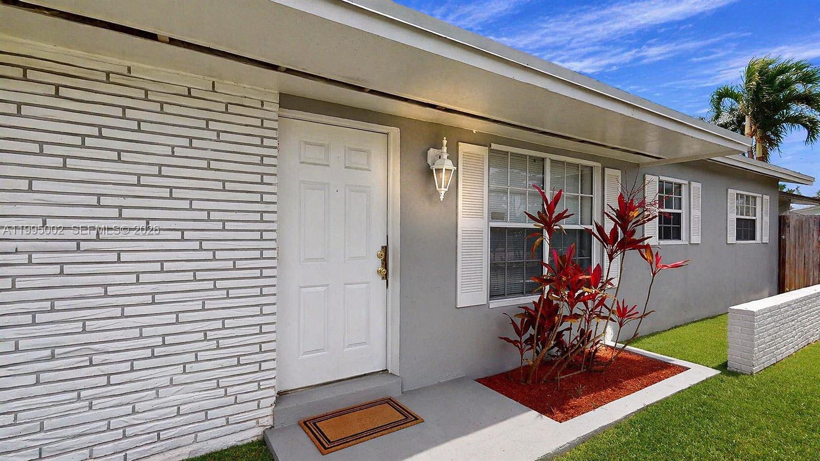 15305 Southwest 104th Avenue Miami, FL 33157 - Photo 1 of 46 a front view of a house with garden
