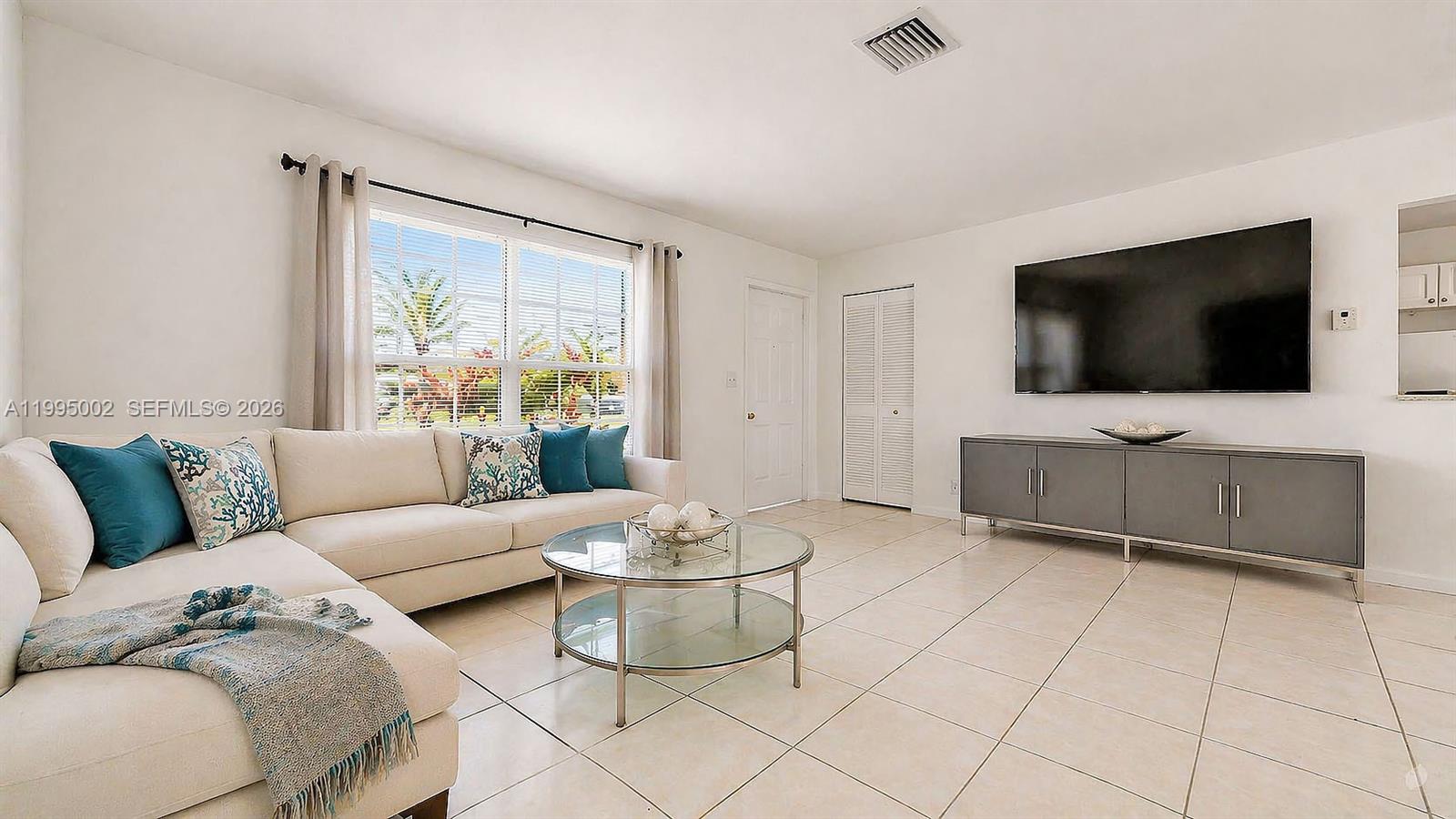 15305 Southwest 104th Avenue Miami, FL 33157 - Photo 15 of 46 a living room with furniture and a flat screen tv