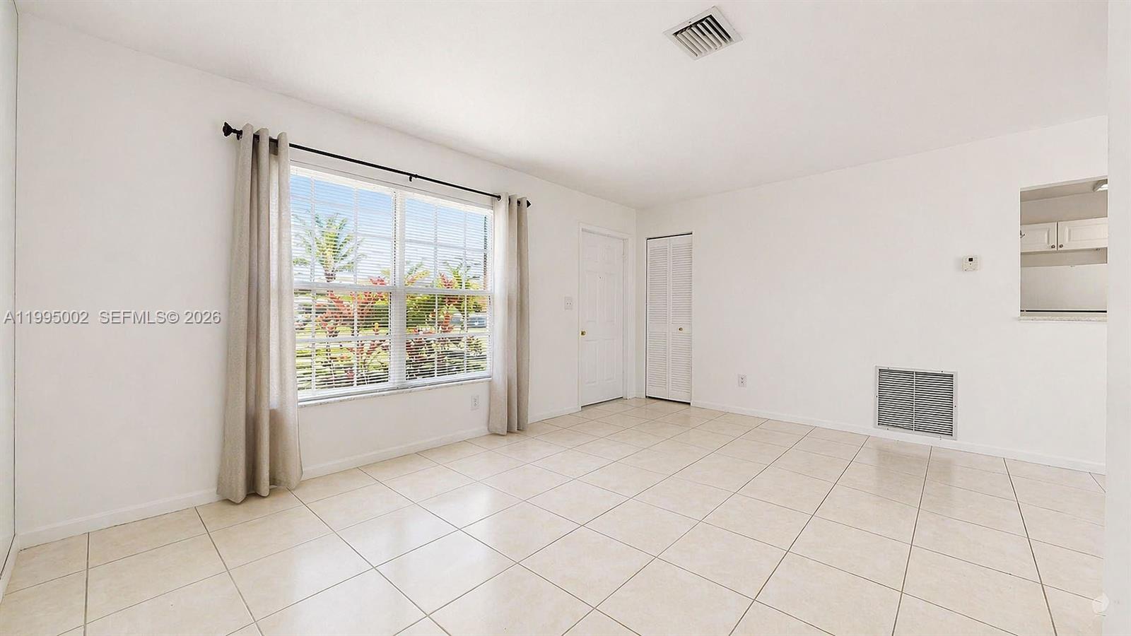 15305 Southwest 104th Avenue Miami, FL 33157 - Photo 16 of 46 a view of an empty room with a window