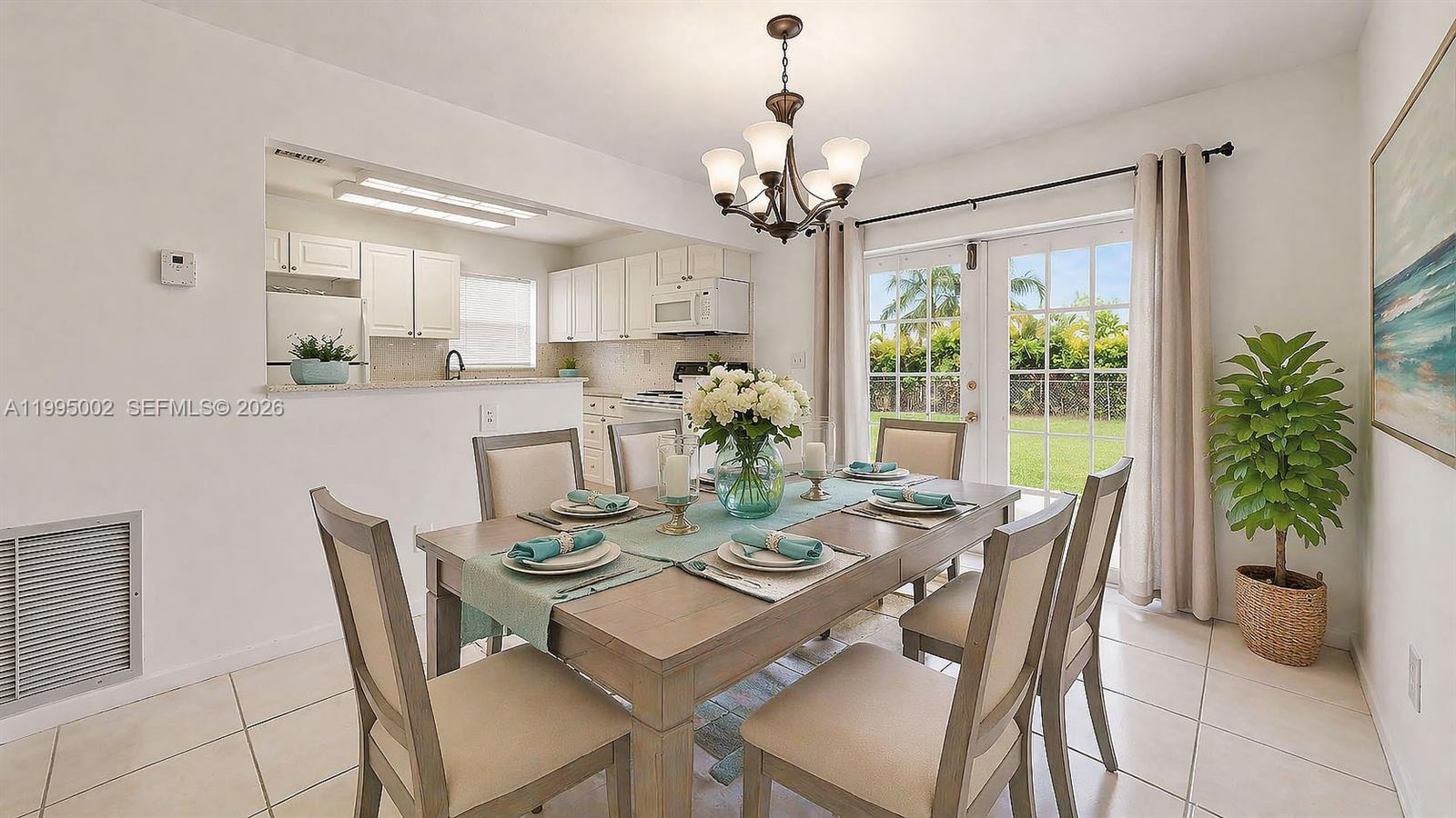 15305 Southwest 104th Avenue Miami, FL 33157 - Photo 19 of 46 a view of a dining room with furniture a chandelier and wooden floor