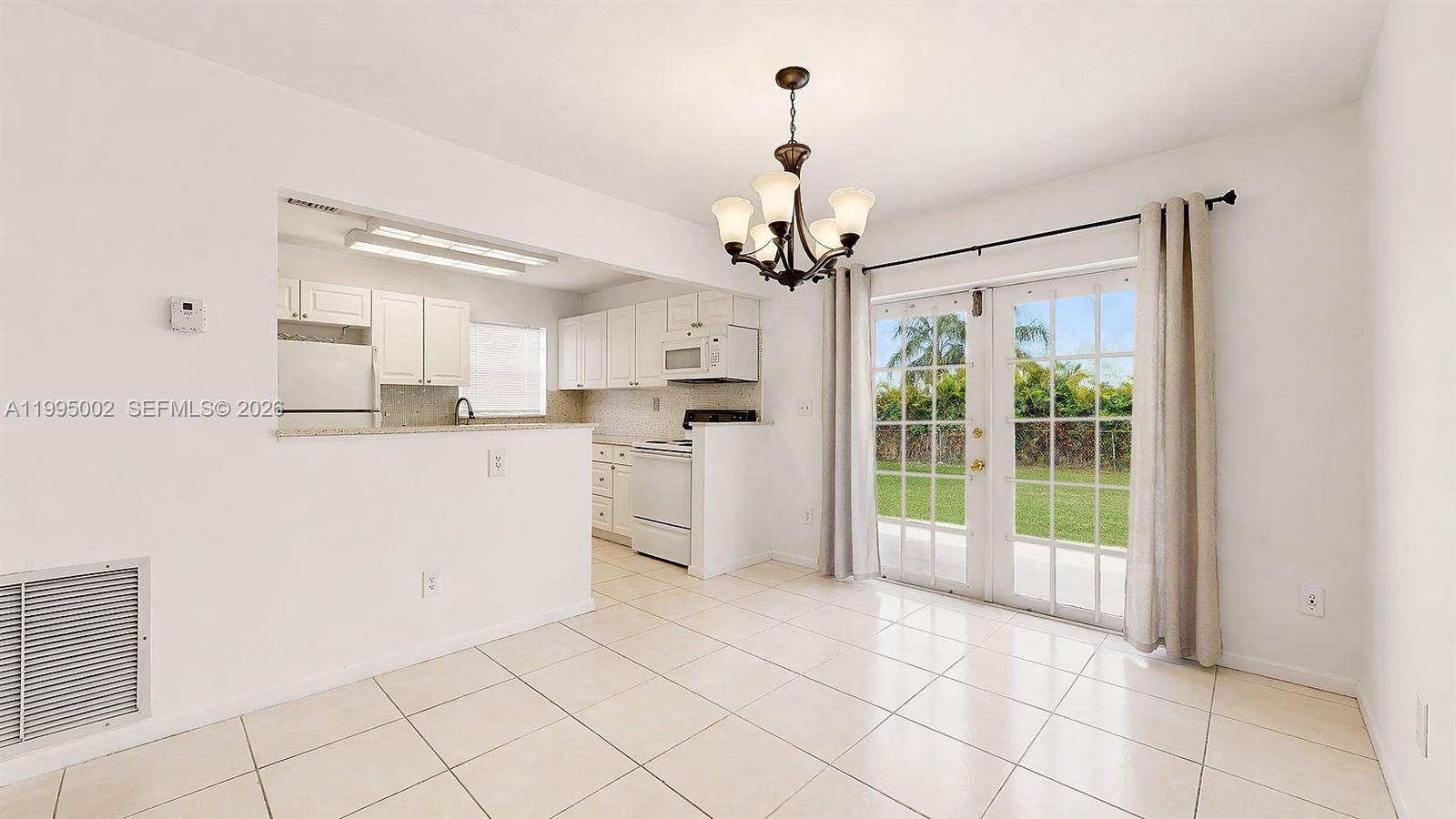 15305 Southwest 104th Avenue Miami, FL 33157 - Photo 20 of 46 a open kitchen with white cabinets and refrigerator