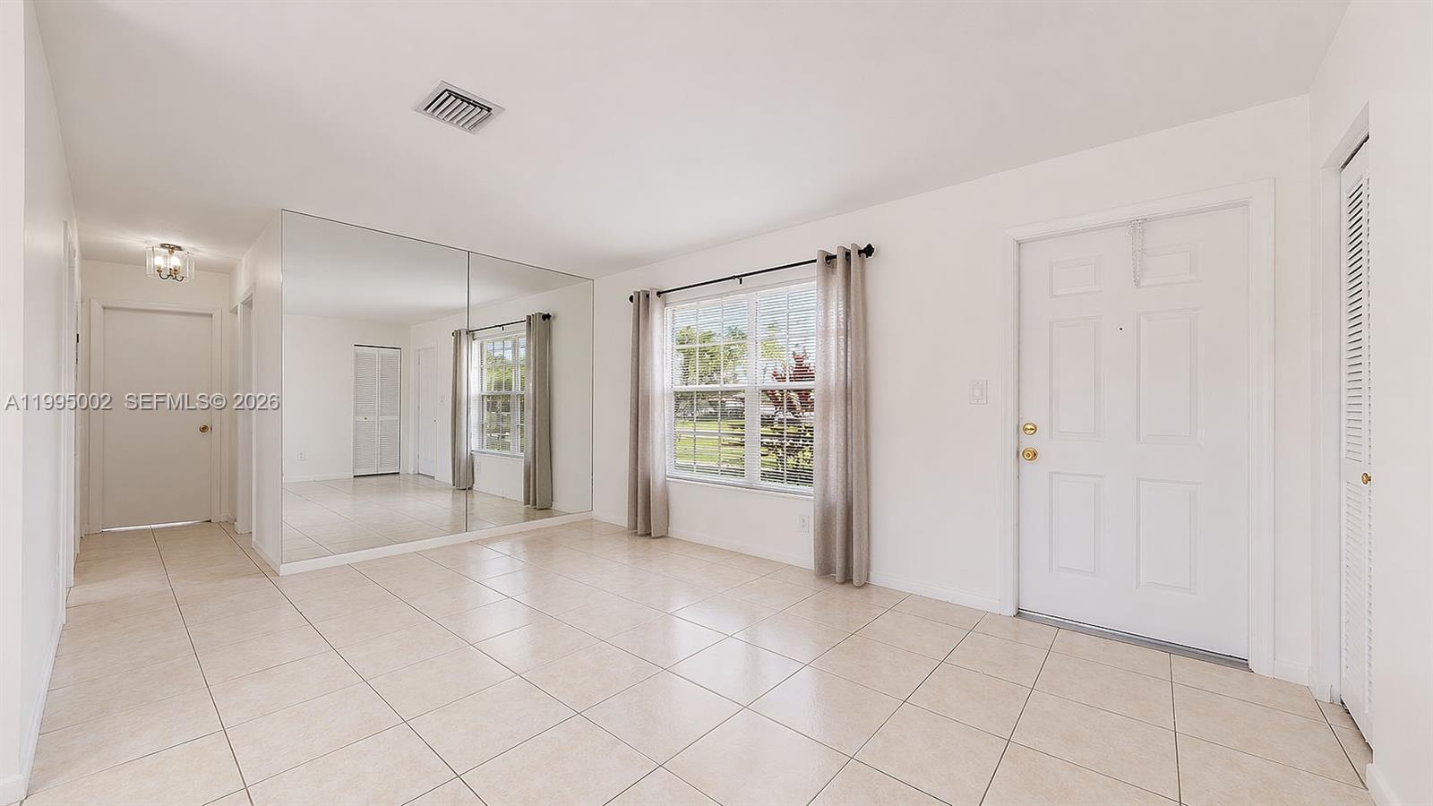 15305 Southwest 104th Avenue Miami, FL 33157 - Photo 26 of 46 a view of an empty room with window and chandelier fan