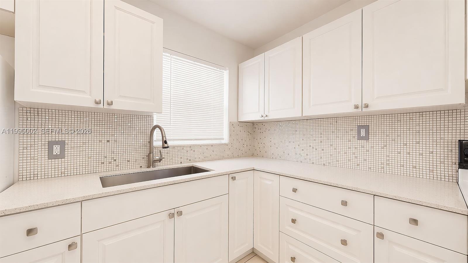 15305 Southwest 104th Avenue Miami, FL 33157 - Photo 28 of 46 a kitchen with white cabinets and a sink