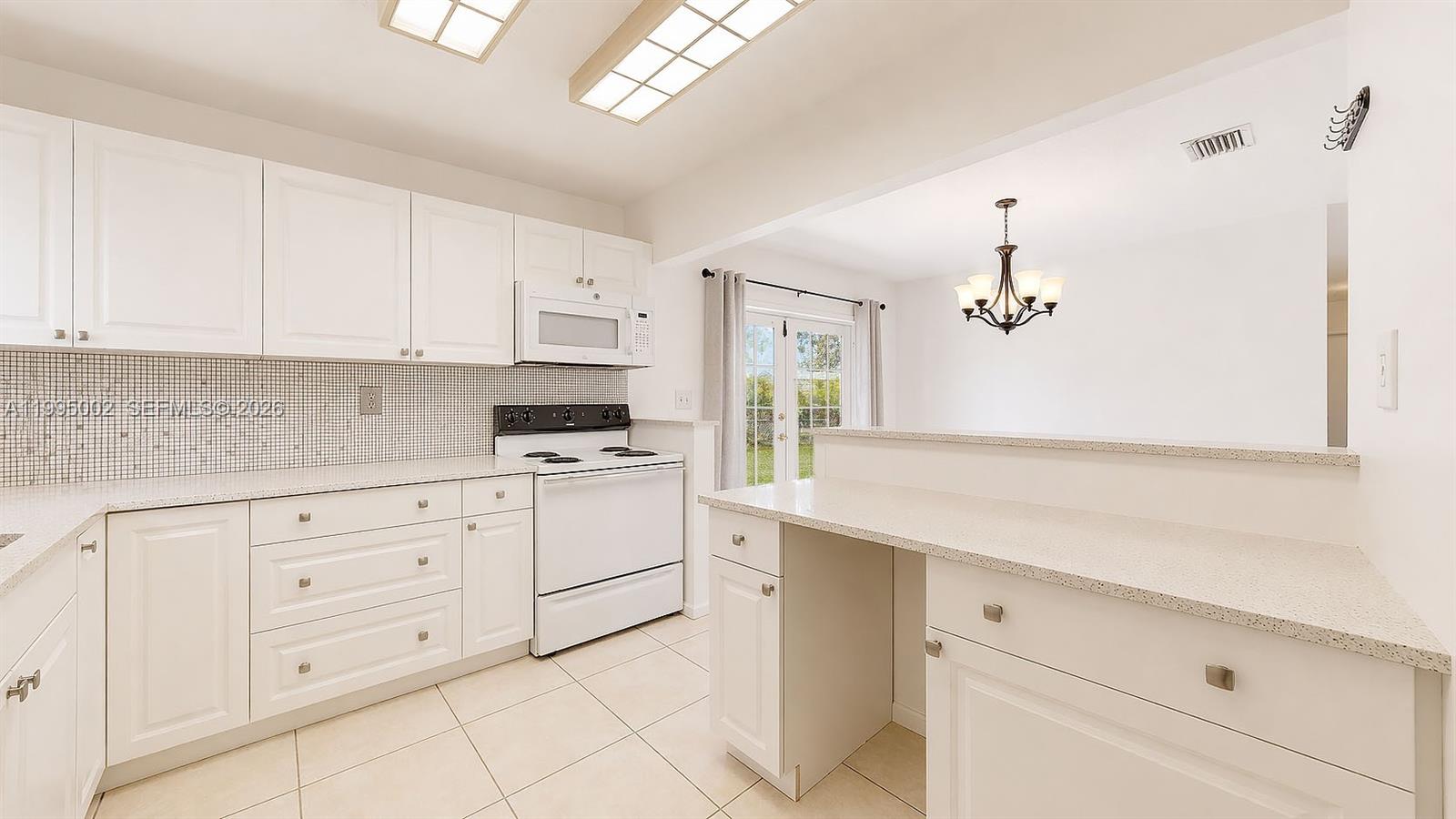 15305 Southwest 104th Avenue Miami, FL 33157 - Photo 29 of 46 a kitchen with cabinets stainless steel appliances and a window