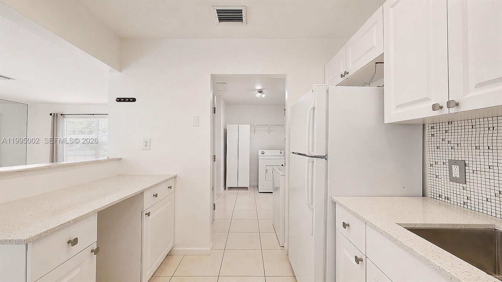 15305 Southwest 104th Avenue Miami, FL 33157 - Photo 30 of 46 a kitchen with a sink cabinets and wooden floor