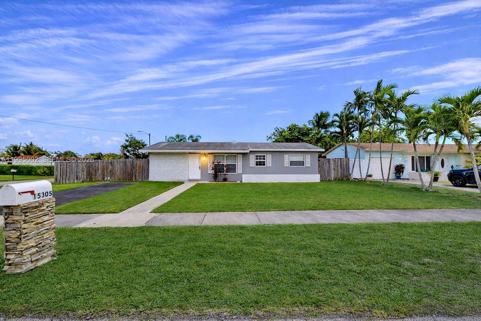 15305 Southwest 104th Avenue Miami, FL 33157 - Photo 3 of 46 a view of a house next to a yard