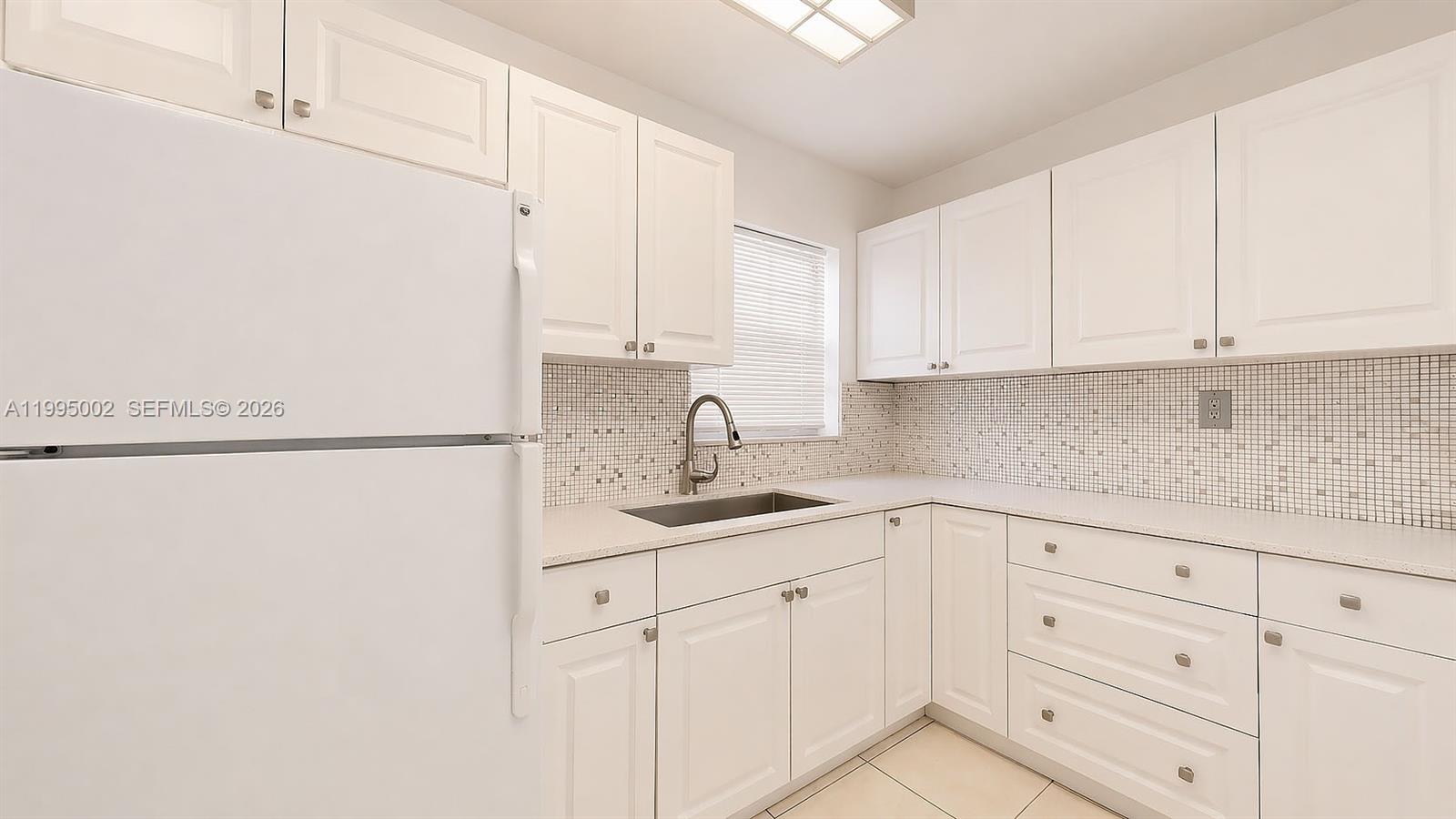 15305 Southwest 104th Avenue Miami, FL 33157 - Photo 31 of 46 a kitchen with white cabinets and white appliances