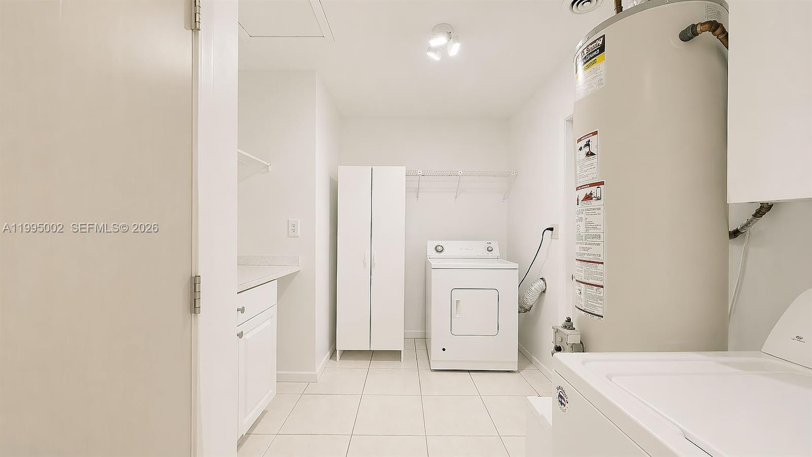15305 Southwest 104th Avenue Miami, FL 33157 - Photo 32 of 46 a bathroom with a sink a mirror and a shower