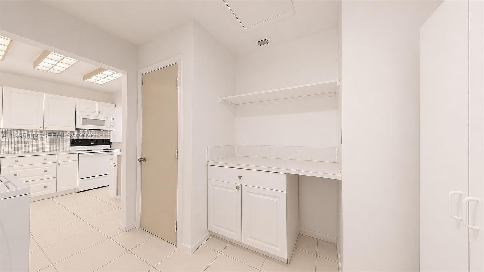 15305 Southwest 104th Avenue Miami, FL 33157 - Photo 33 of 46 a kitchen with white cabinets and white appliances