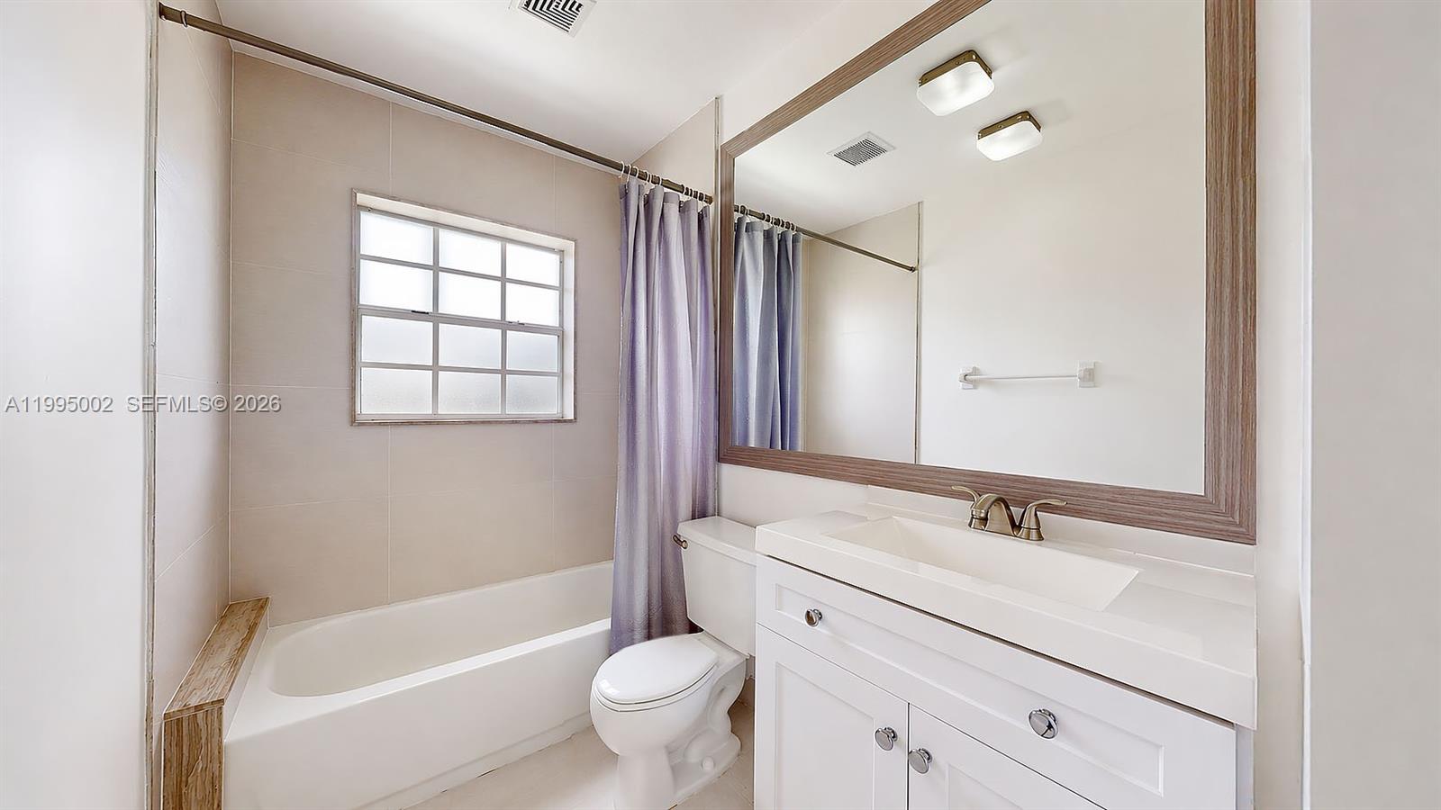 15305 Southwest 104th Avenue Miami, FL 33157 - Photo 39 of 46 a bathroom with a double vanity sink toilet mirror and bathtub