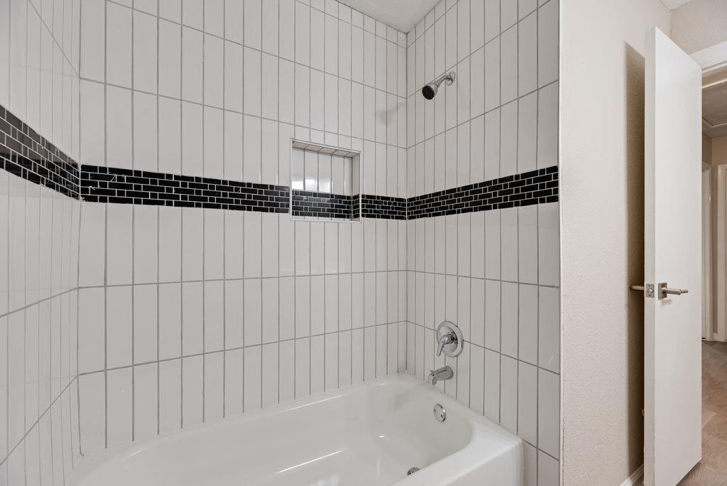 5706 Rocky Ridge Road Dallas, TX 75241 - Photo 20 of 31 a bathroom with a bathtub