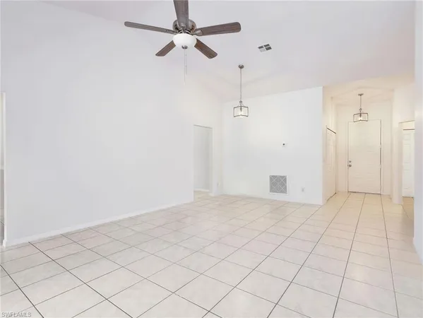 an empty room with fan and window