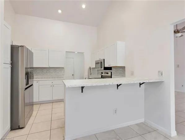 a kitchen with a sink cabinets and appliances
