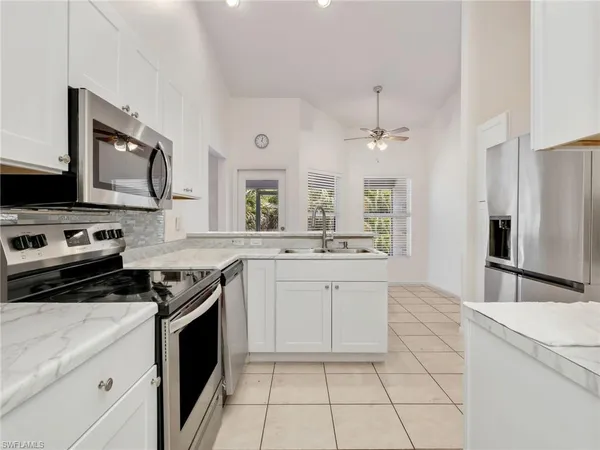 a kitchen with a sink stove and refrigerator