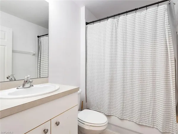 a bathroom with a sink a toilet and vanity