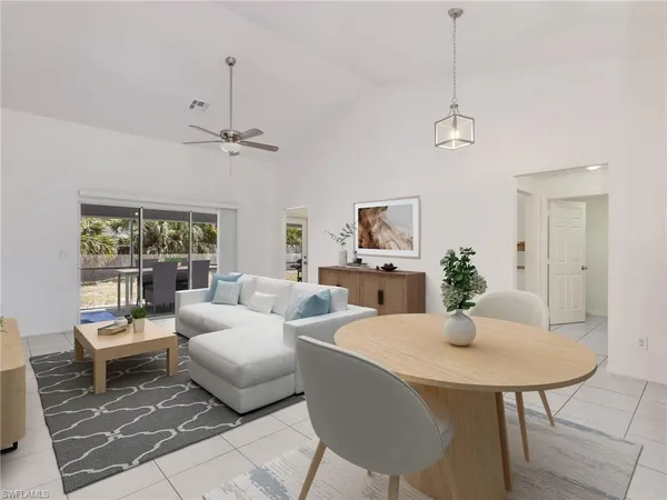 a living room with furniture a chandelier and a window