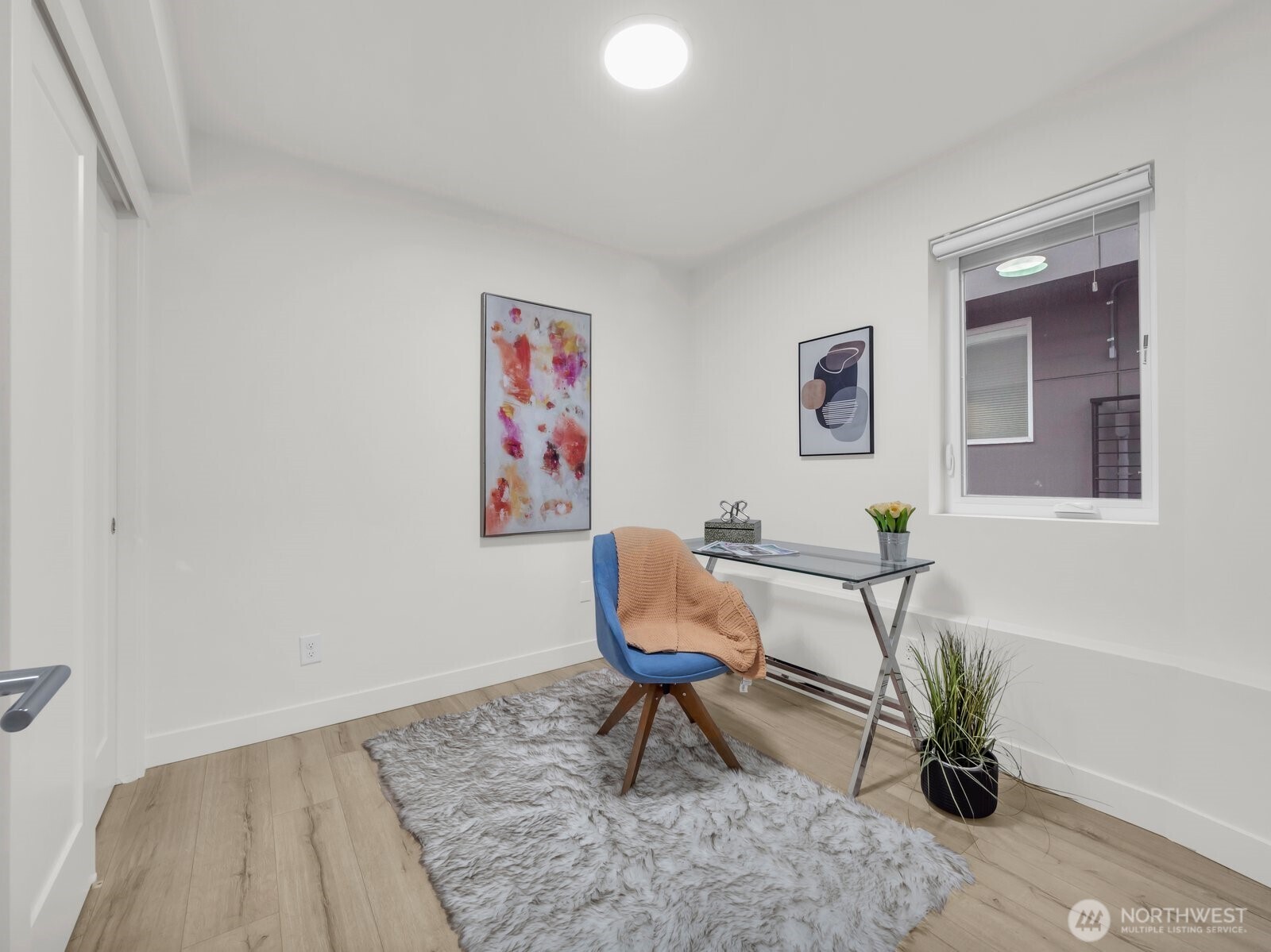 3628 14th Avenue South Seattle, WA 98144 - Photo 2 of 27 a workspace with furniture and a potted plant