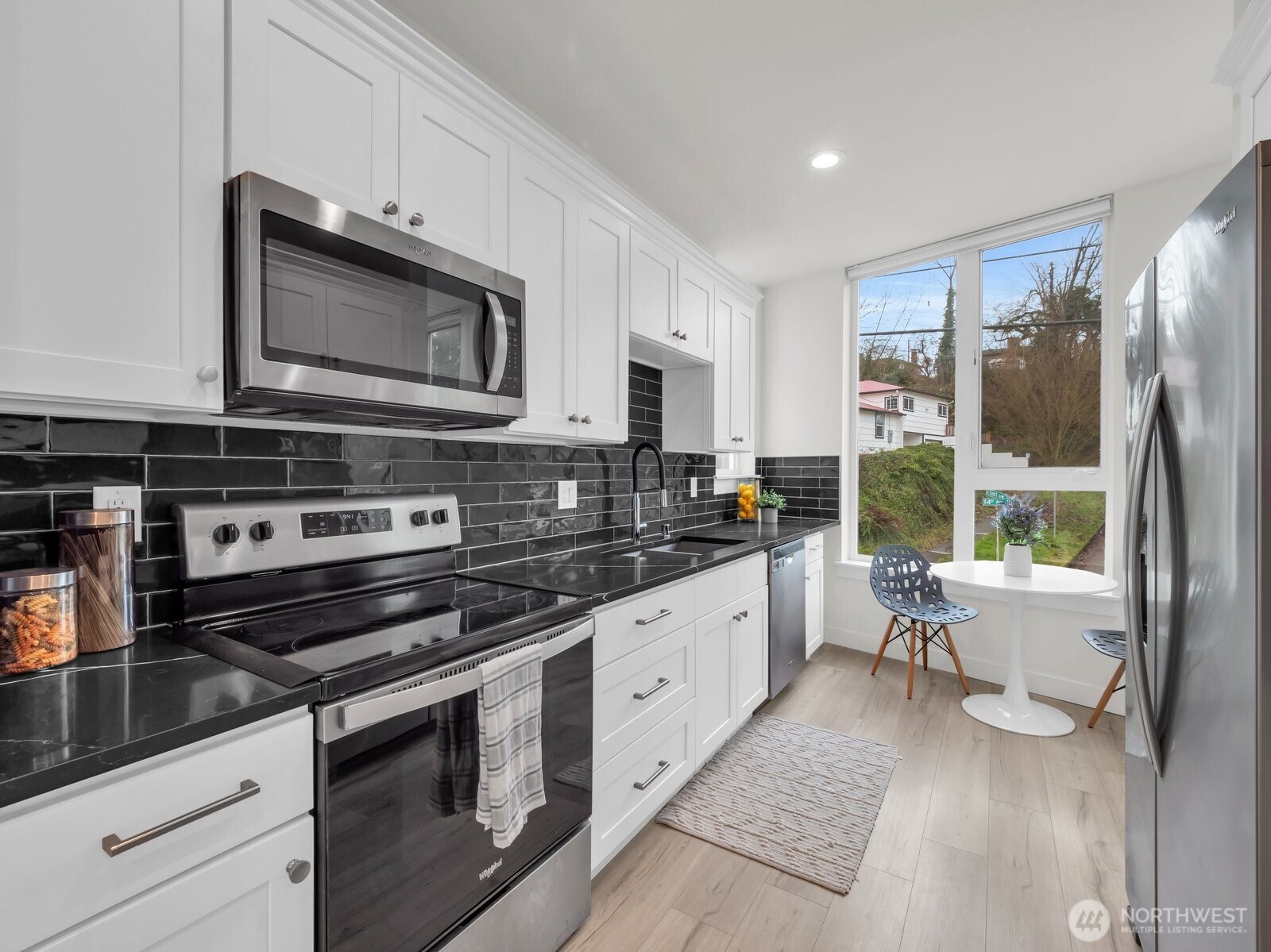 3628 14th Avenue South Seattle, WA 98144 - Photo 9 of 27 a kitchen with stainless steel appliances a stove microwave and sink