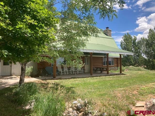 25558 Rd N 6 Loop Cortez, CO 81321 - Photo 1 of 30 a view of a patio with a table chairs and garden