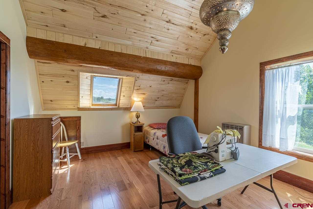 25558 Rd N 6 Loop Cortez, CO 81321 - Photo 19 of 30 a living room with furniture and wooden floor