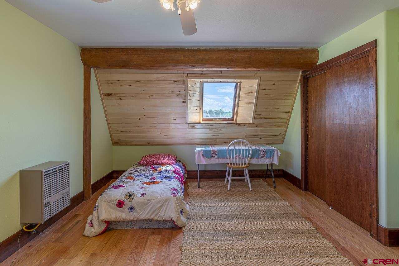 25558 Rd N 6 Loop Cortez, CO 81321 - Photo 20 of 30 a bedroom with a bed and a chair in it