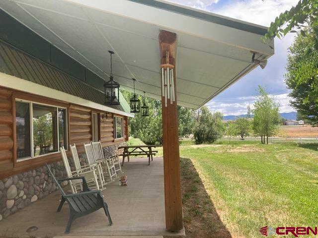 25558 Rd N 6 Loop Cortez, CO 81321 - Photo 2 of 30 a view of a patio with a table chairs and garden