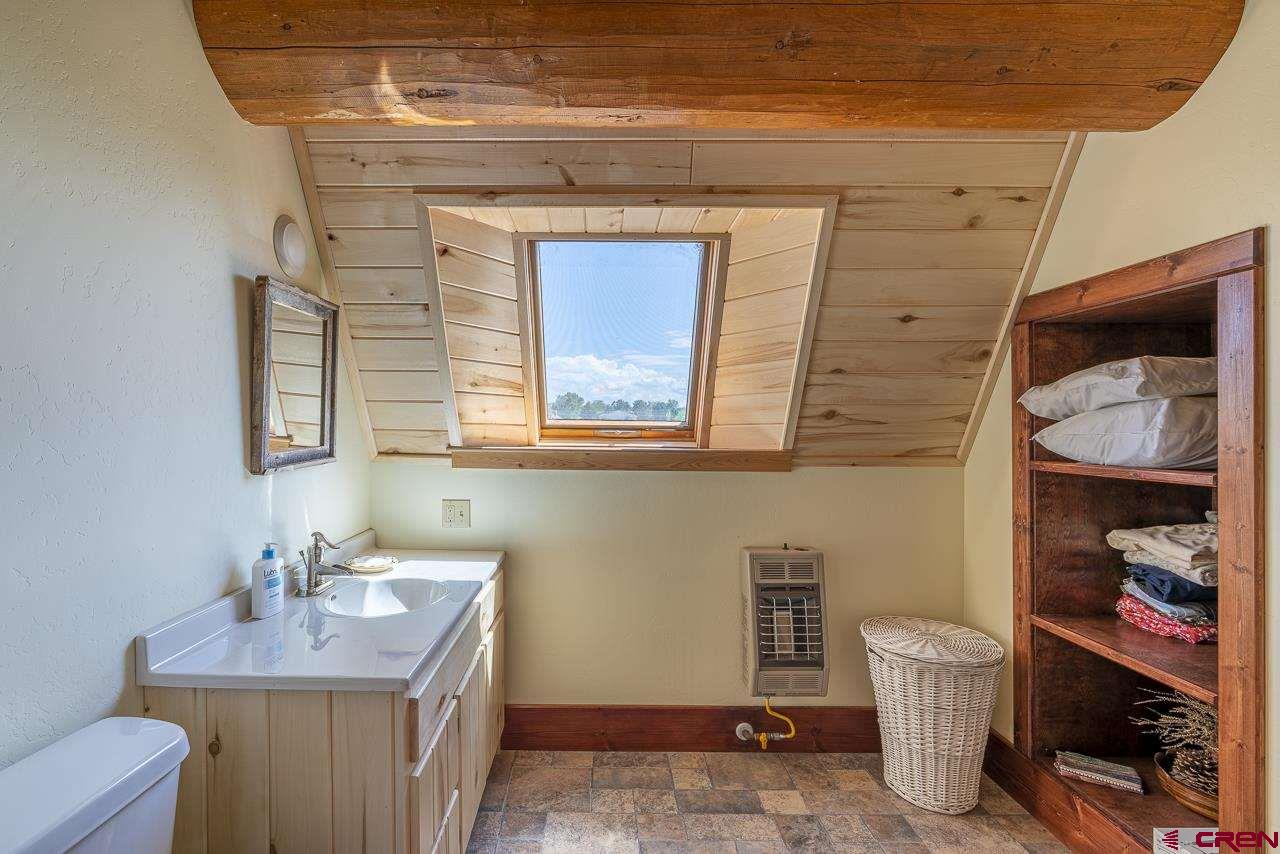 25558 Rd N 6 Loop Cortez, CO 81321 - Photo 21 of 30 a bathroom with a toilet a sink and mirror