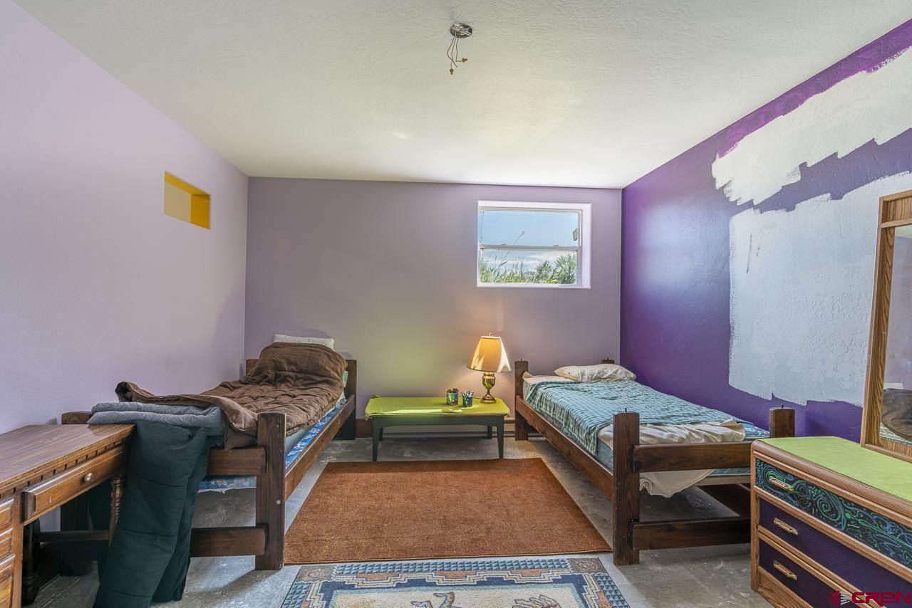 25558 Rd N 6 Loop Cortez, CO 81321 - Photo 23 of 30 a bedroom with two beds and a desk